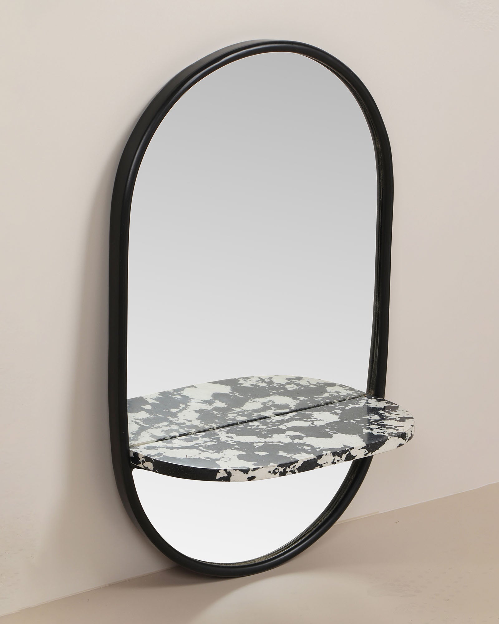 Modern wall mirror with built-in shelf for décor and essentials.