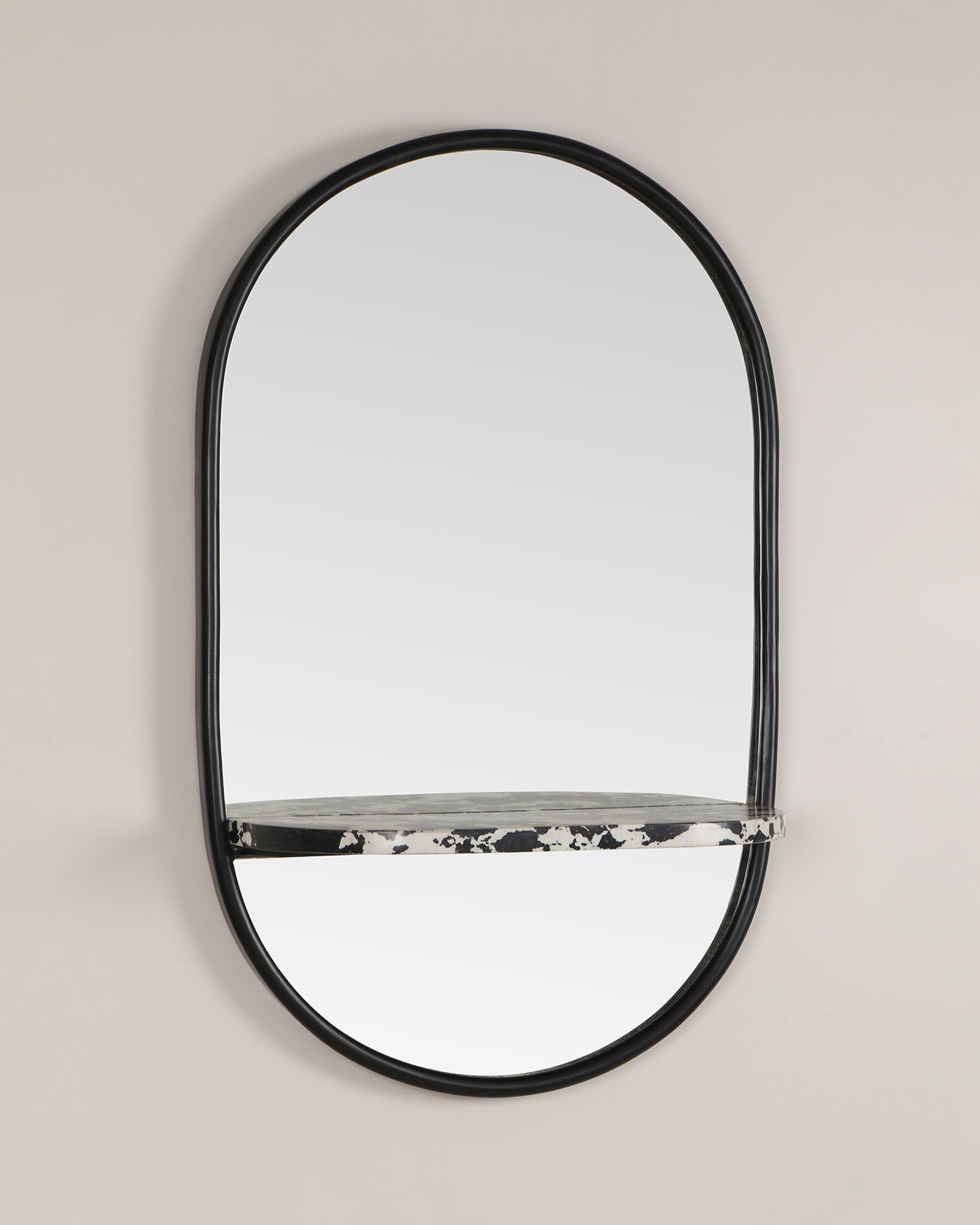 Modern wall mirror with built-in shelf for décor and essentials.
