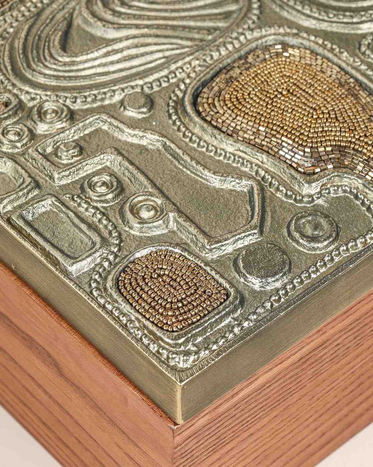 Luxury brass jewelry storage box with sculptural design and handcrafted texture.