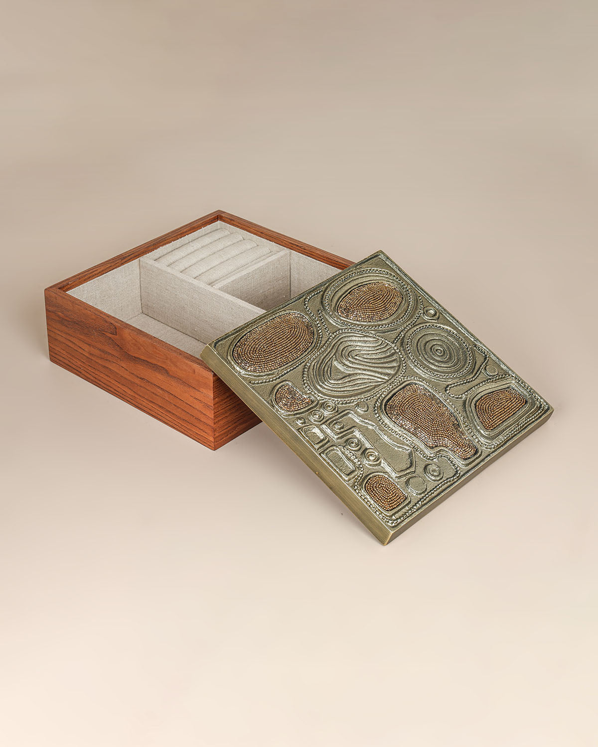 Luxury brass jewelry storage box with sculptural design and handcrafted texture.