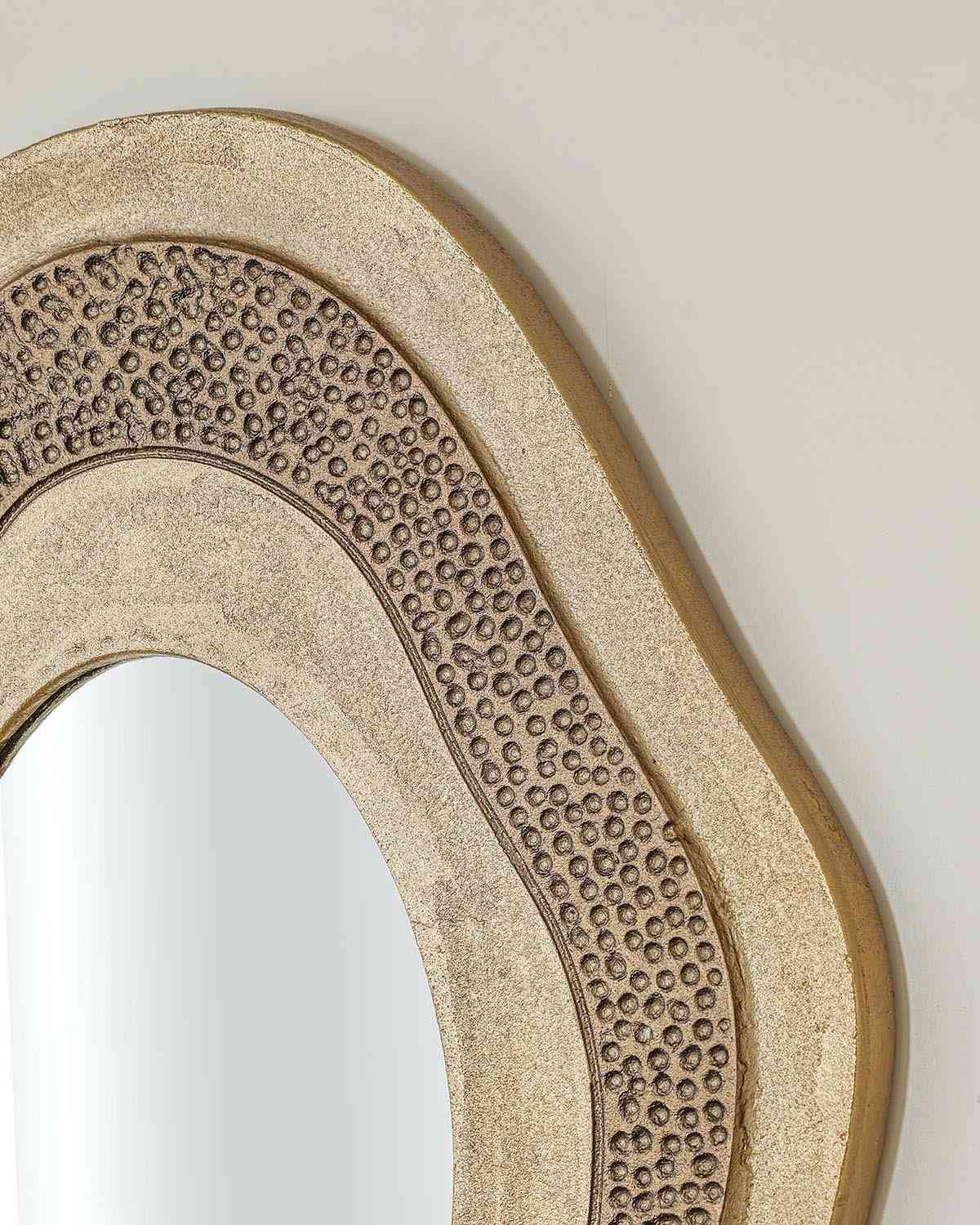 Osric luxury mirror with elongated antique brass frame and designed mirror glass.