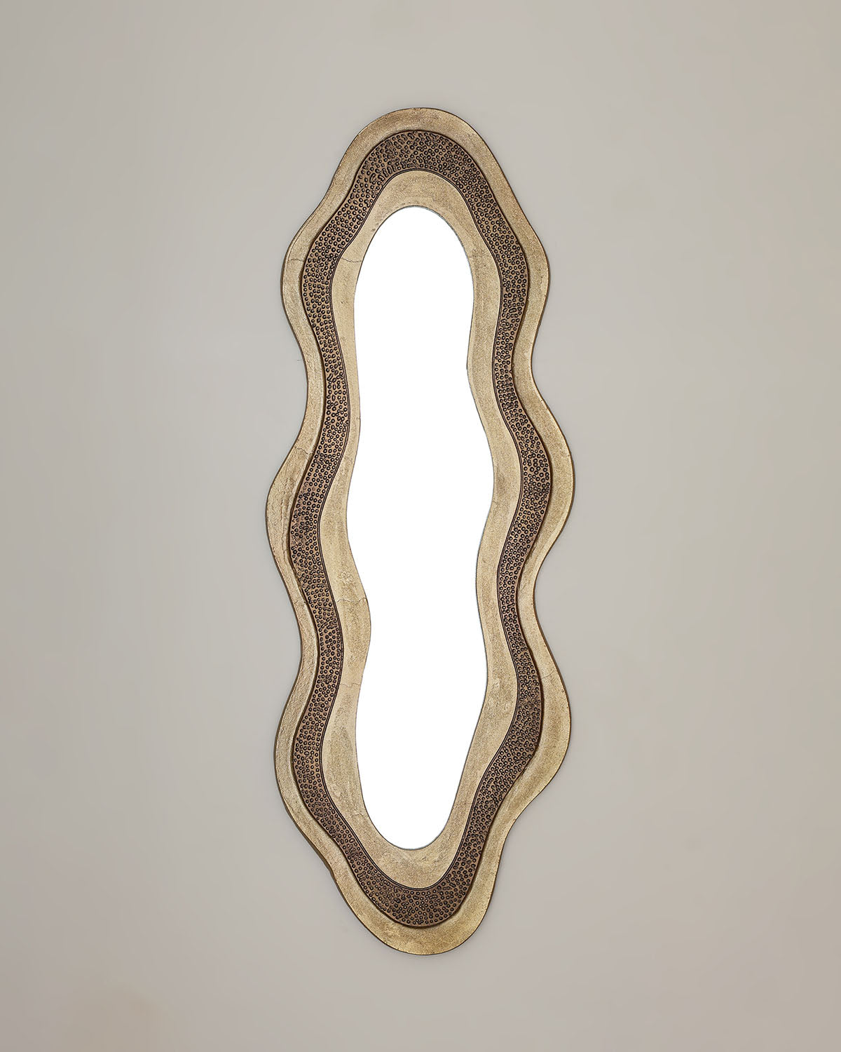 Osric luxury mirror with elongated antique brass frame and designed mirror glass.
