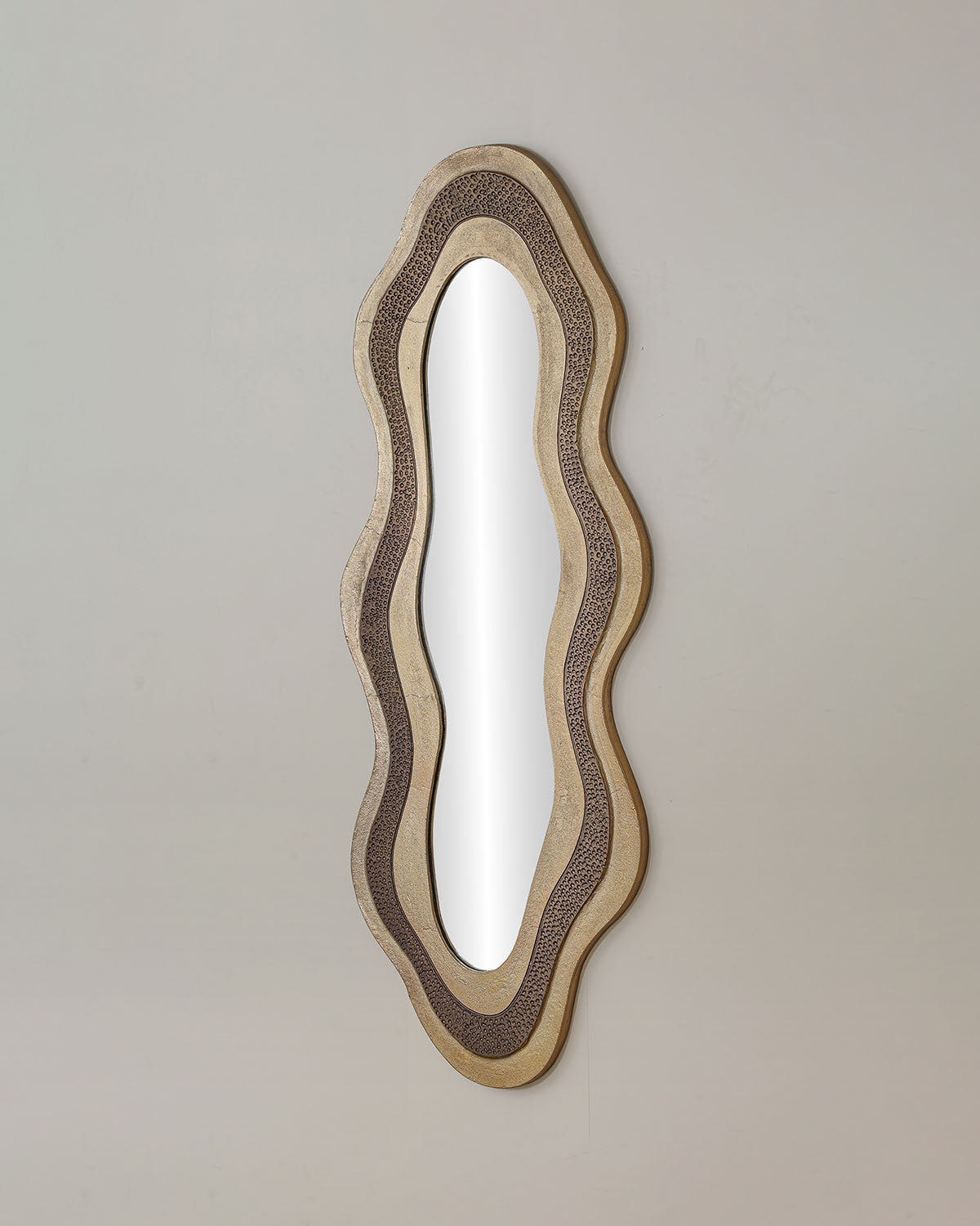 Osric luxury mirror with elongated antique brass frame and designed mirror glass.